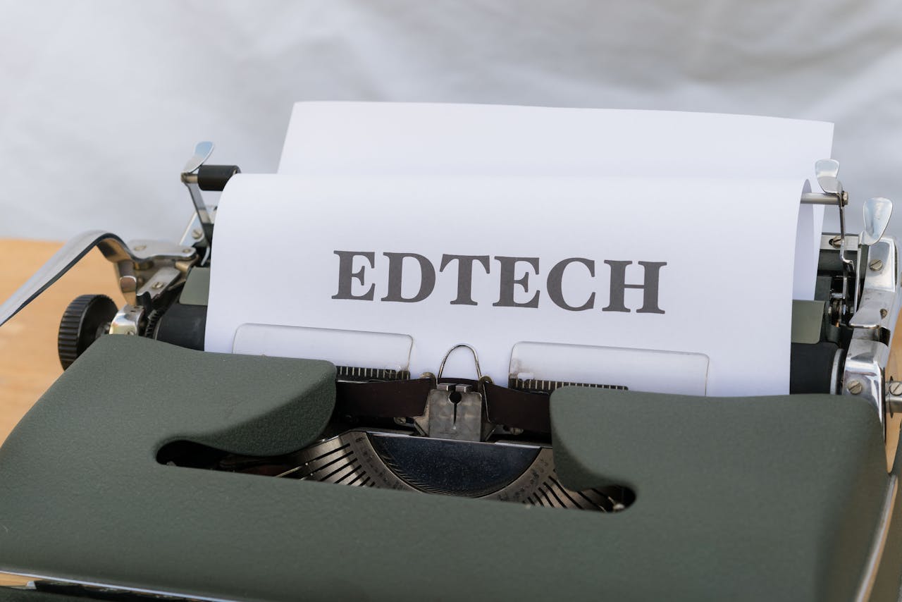 A vintage typewriter with a paper labeled 'EDTECH', signifying educational technology.